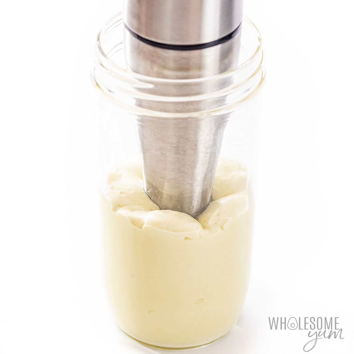 Homemade mayonnaise recipe forming in jar.