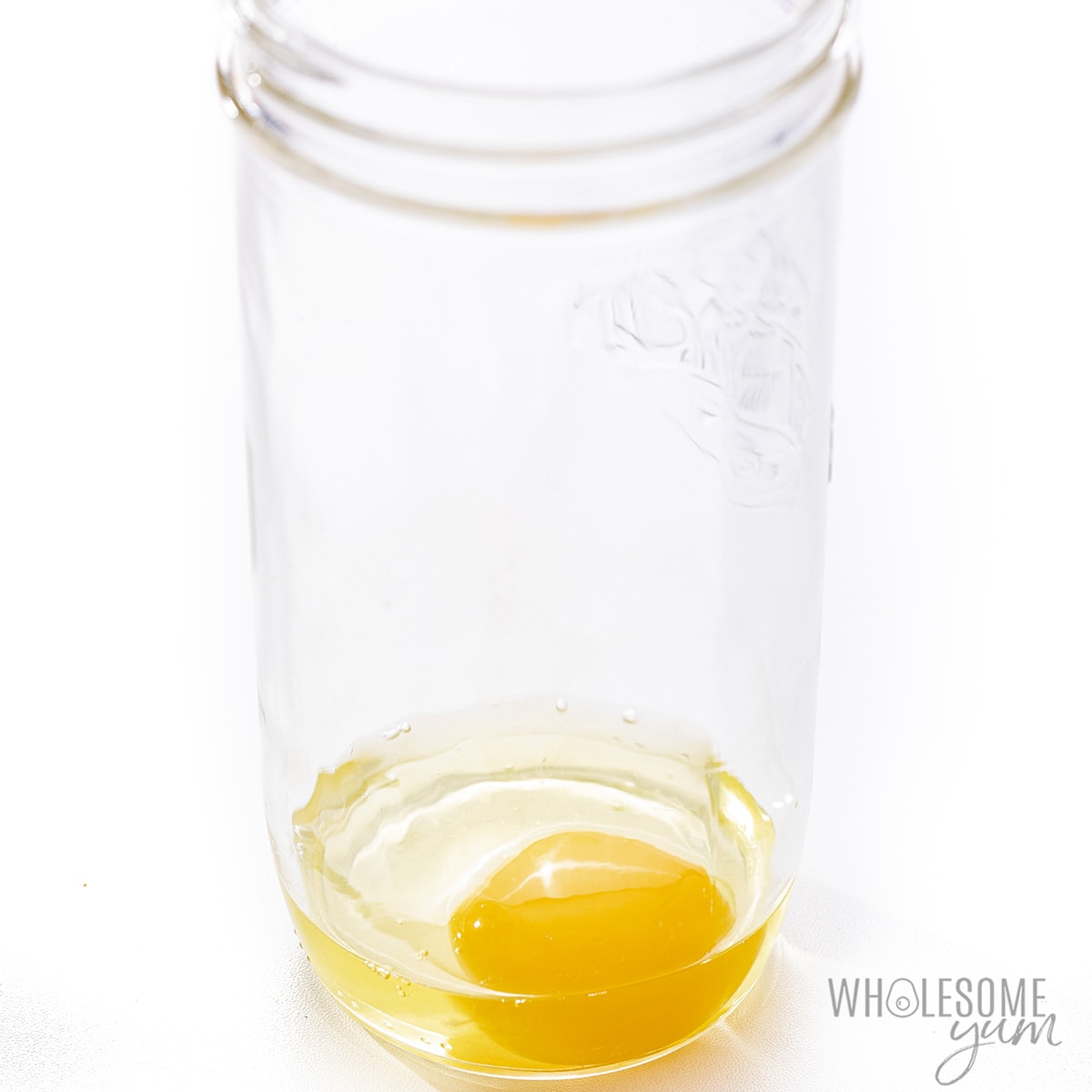 Egg in the bottom of a glass jar.