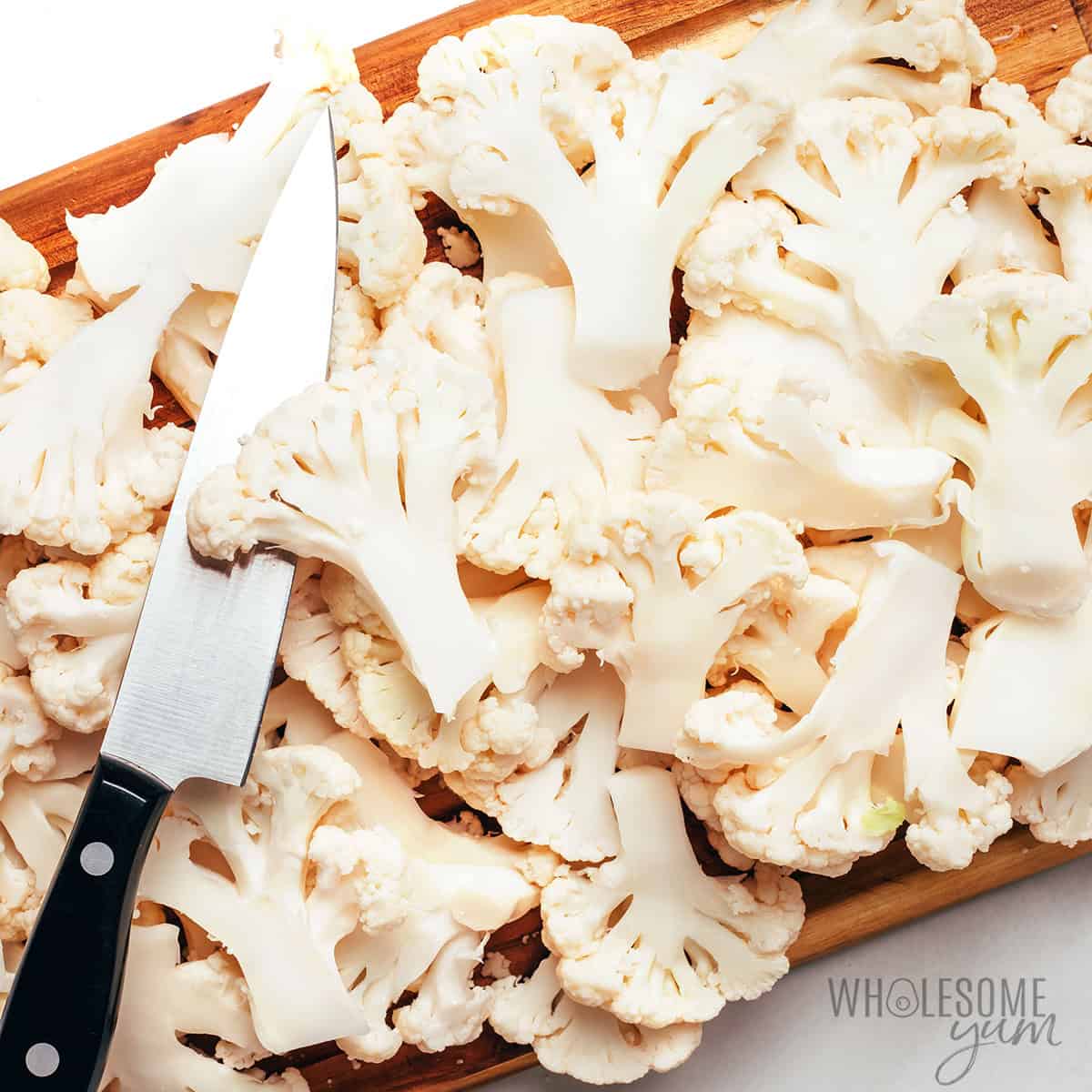 Cauliflower chips on a cutting board.