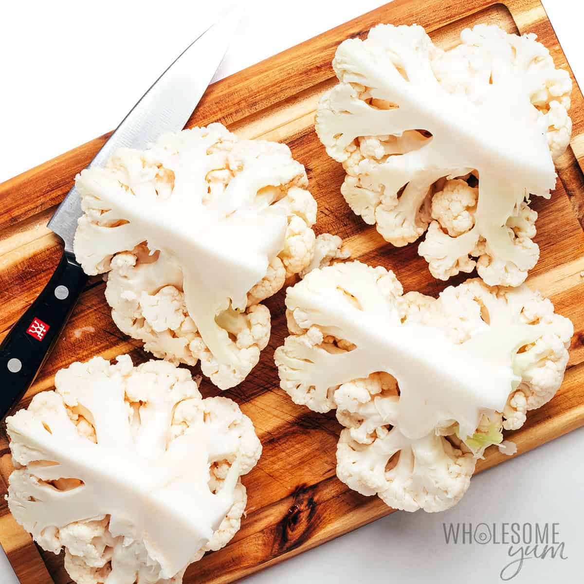 Head of cauliflower cut into quarters.