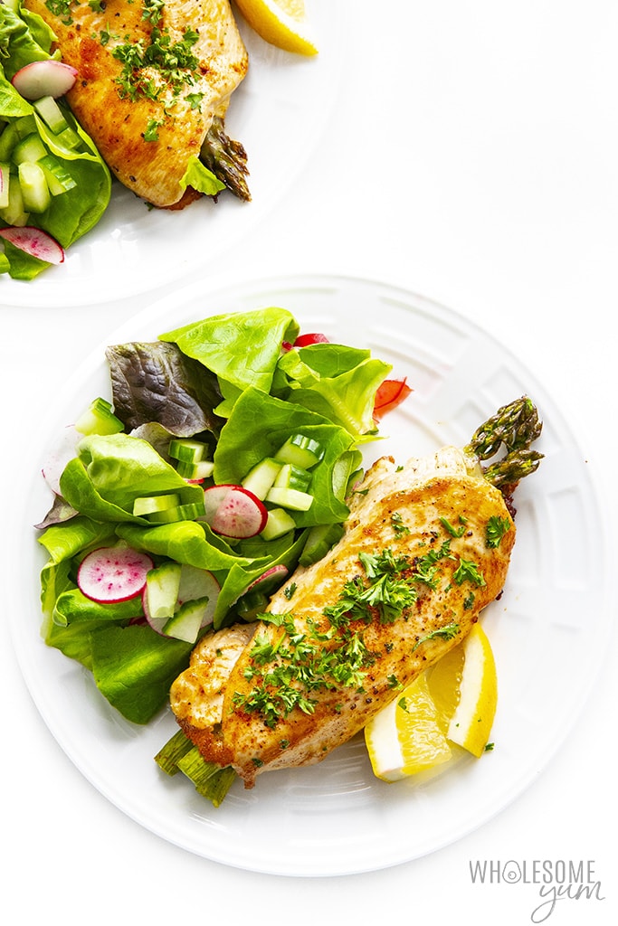 Healthy asparagus stuffed chicken on a plate overhead