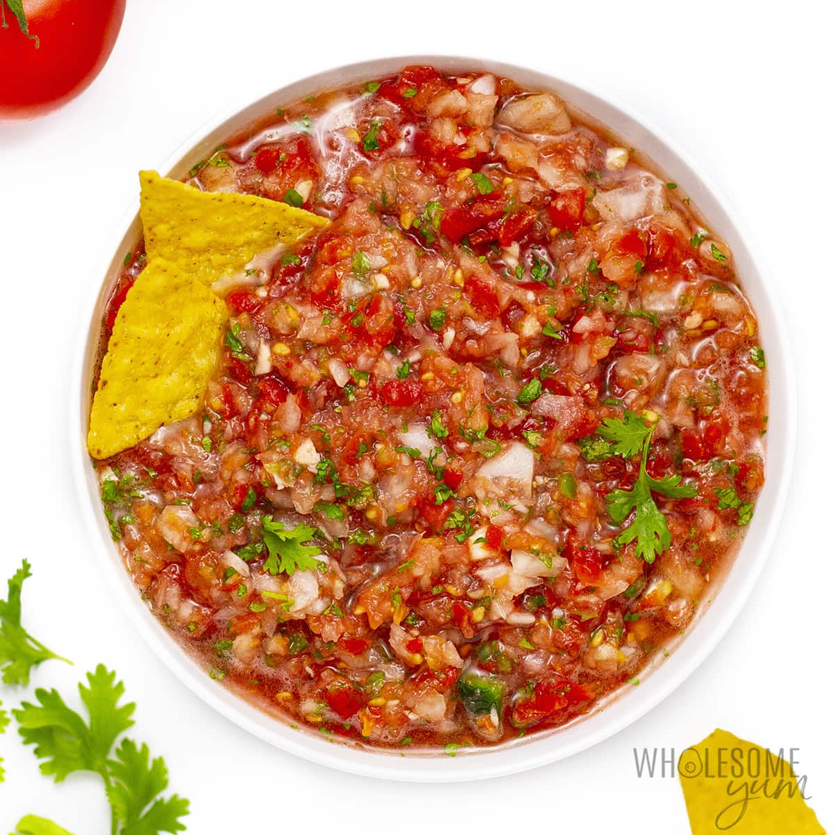 Salsa with fresh tomatoes fully blended and served in a bowl.