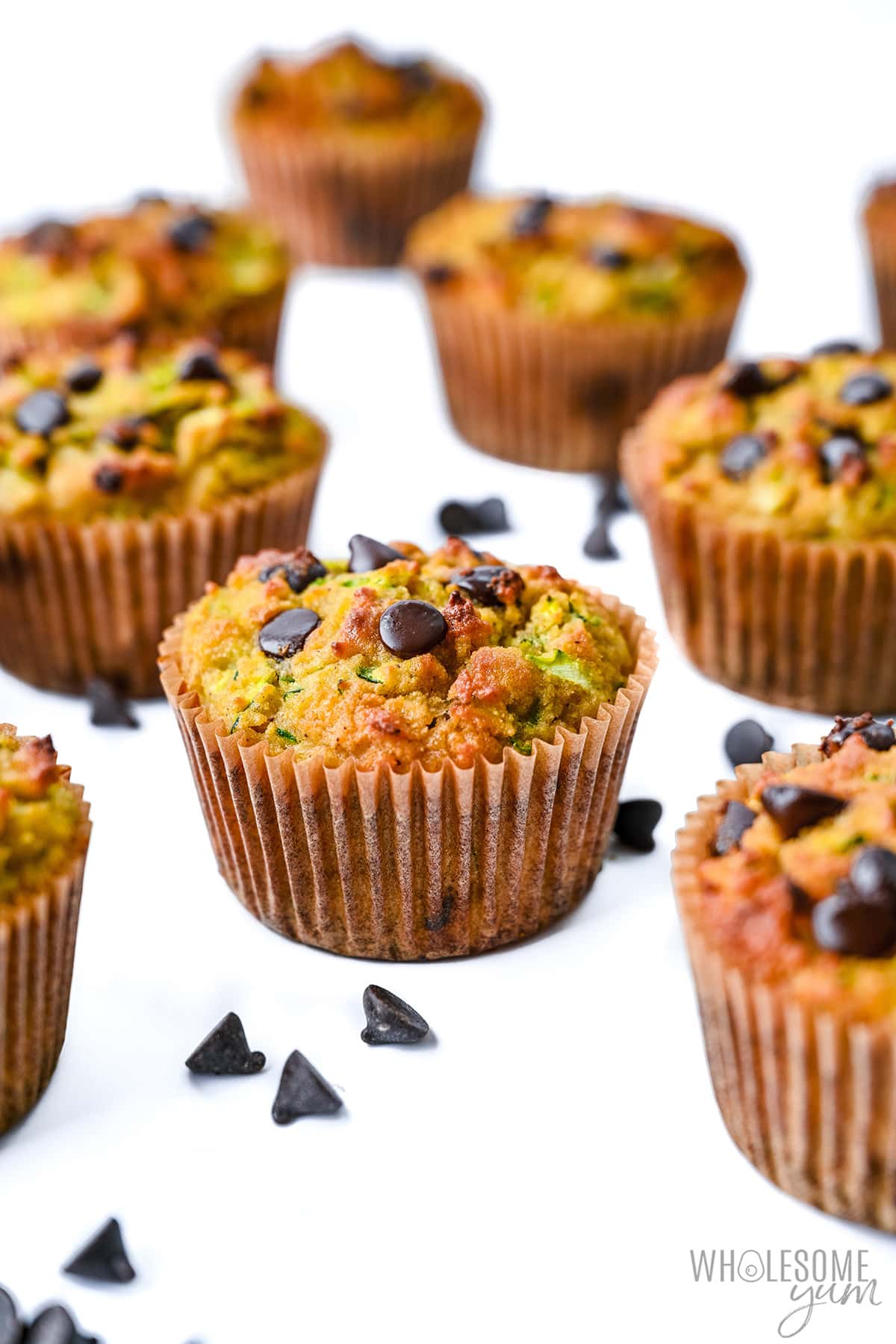 Healthy zucchini muffins on a white surface.