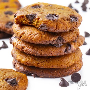 Stack of protein chocolate chip cookies with one bite taken out of top cookie