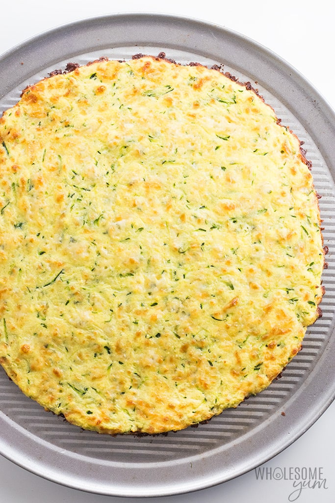 The Best Zucchini Pizza Crust Recipe - Low Carb, 4 Ingredients - The BEST zucchini pizza crust recipe - low carb, super easy, 4 ingredients, NO squeezing required, and you can PICK IT UP! Plus, lots of tips and instructions for freezing zucchini crust pizza.