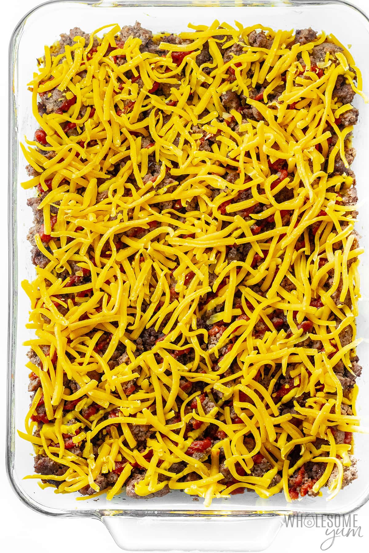 Cheese sprinkled on top of ground beef mixture.