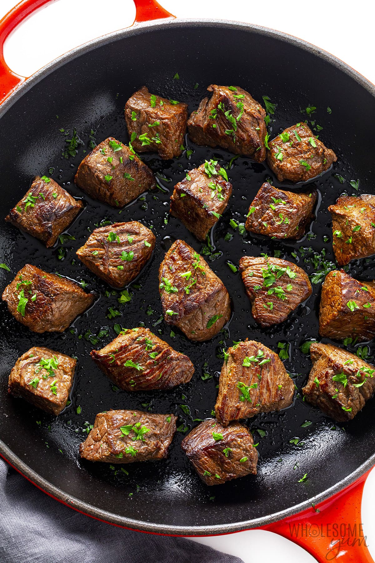 Sirloin tips in a cast iron skillet.