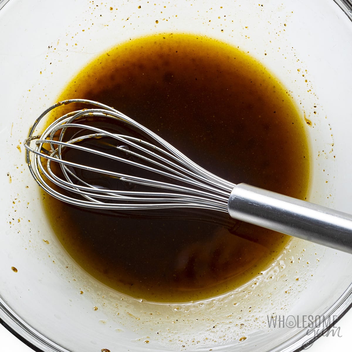Marinade in a bowl with a whisk.