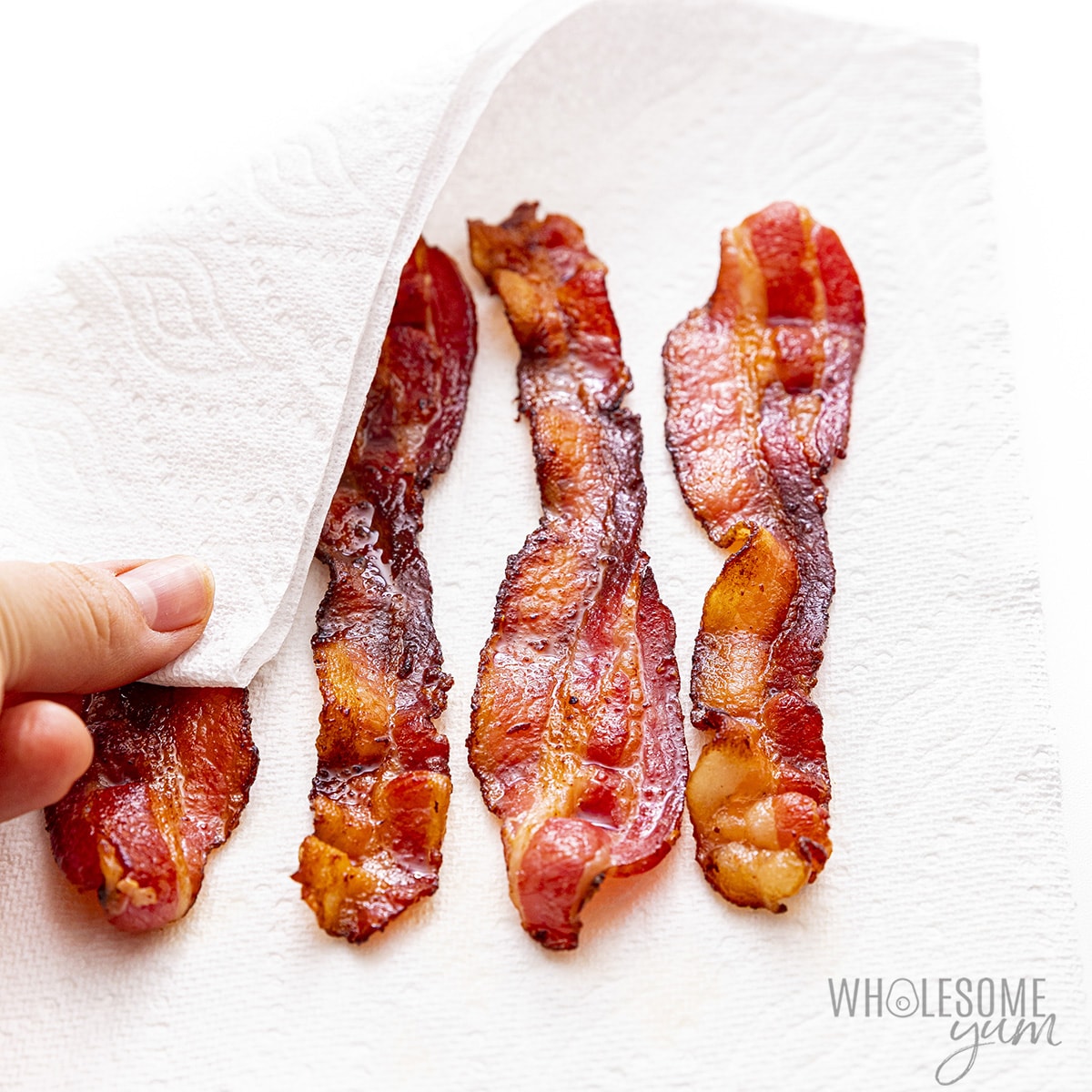 Place cooked bacon on paper towels.