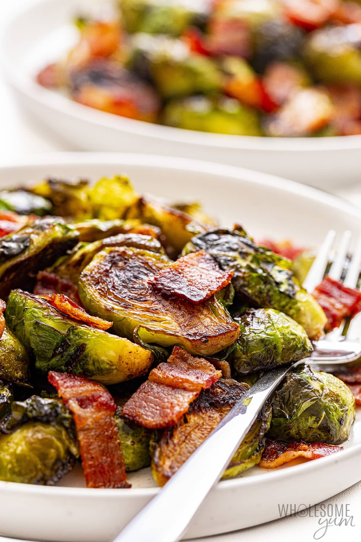Sautéed Brussels sprouts on plate, side view.