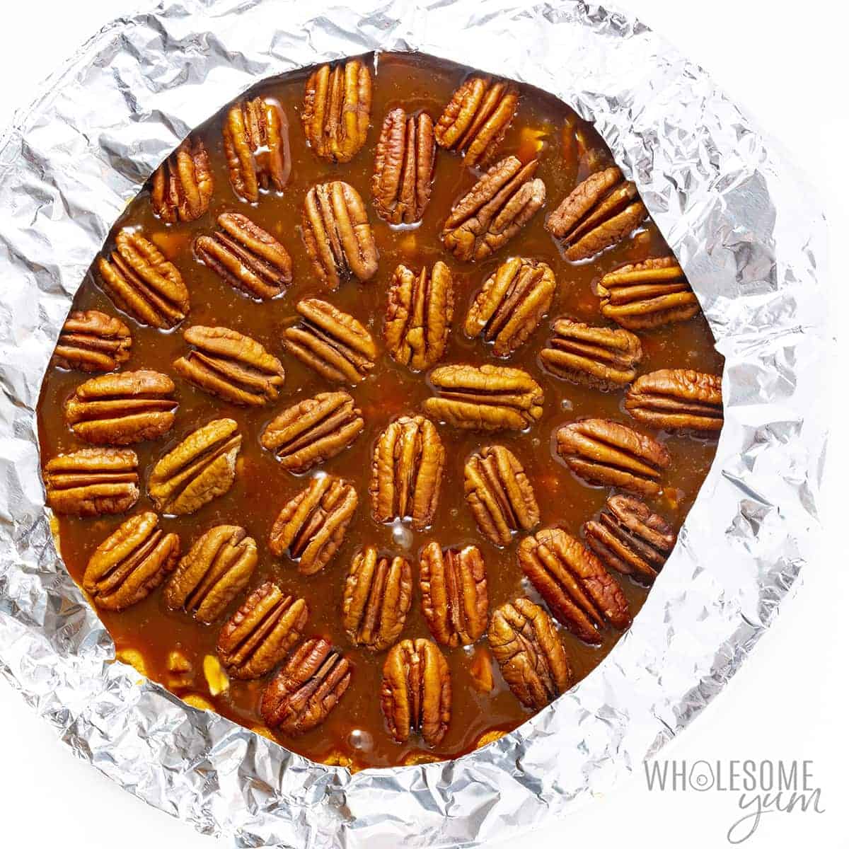 Keto pecan pie before baking, with crust edges covered