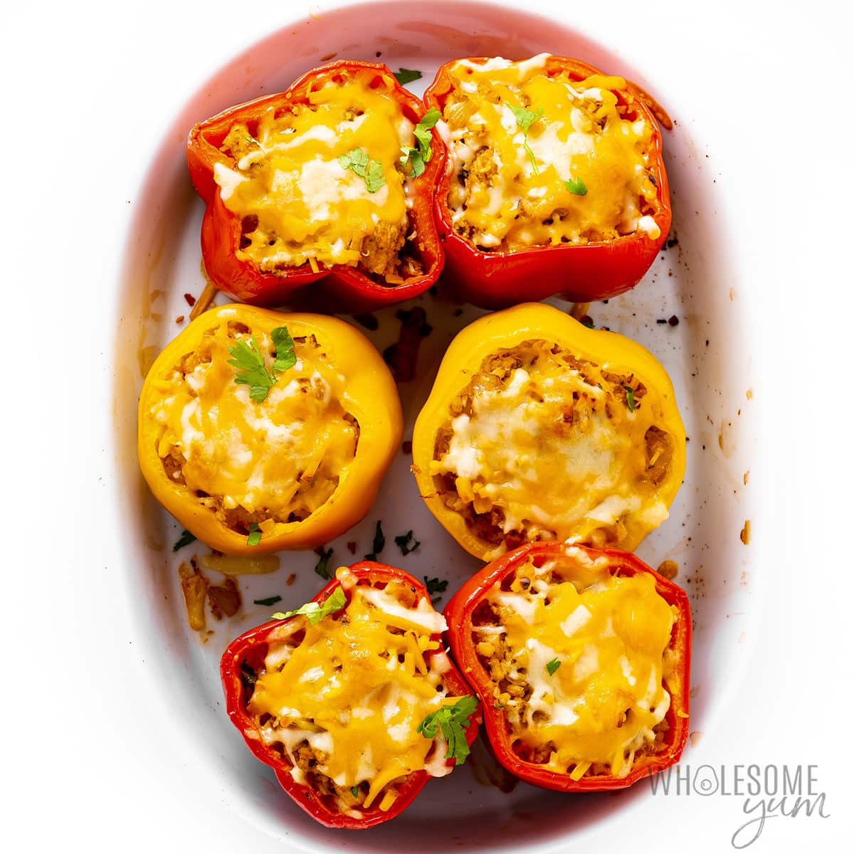 Chicken stuffed peppers cooked in a casserole.