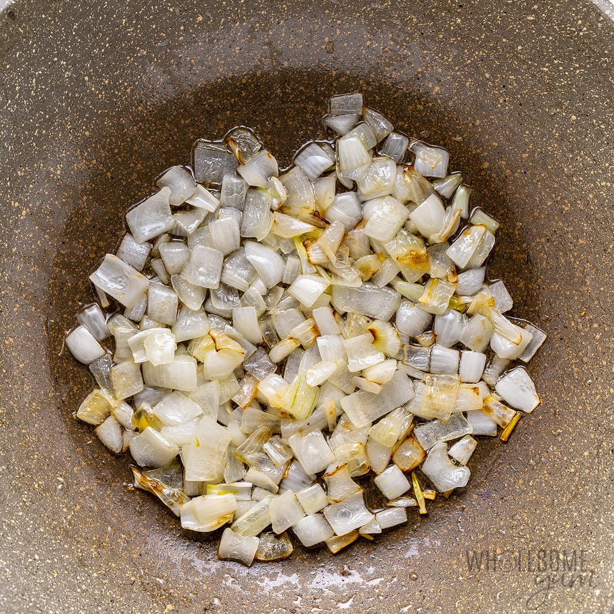 Chopped onions in a frying pan.