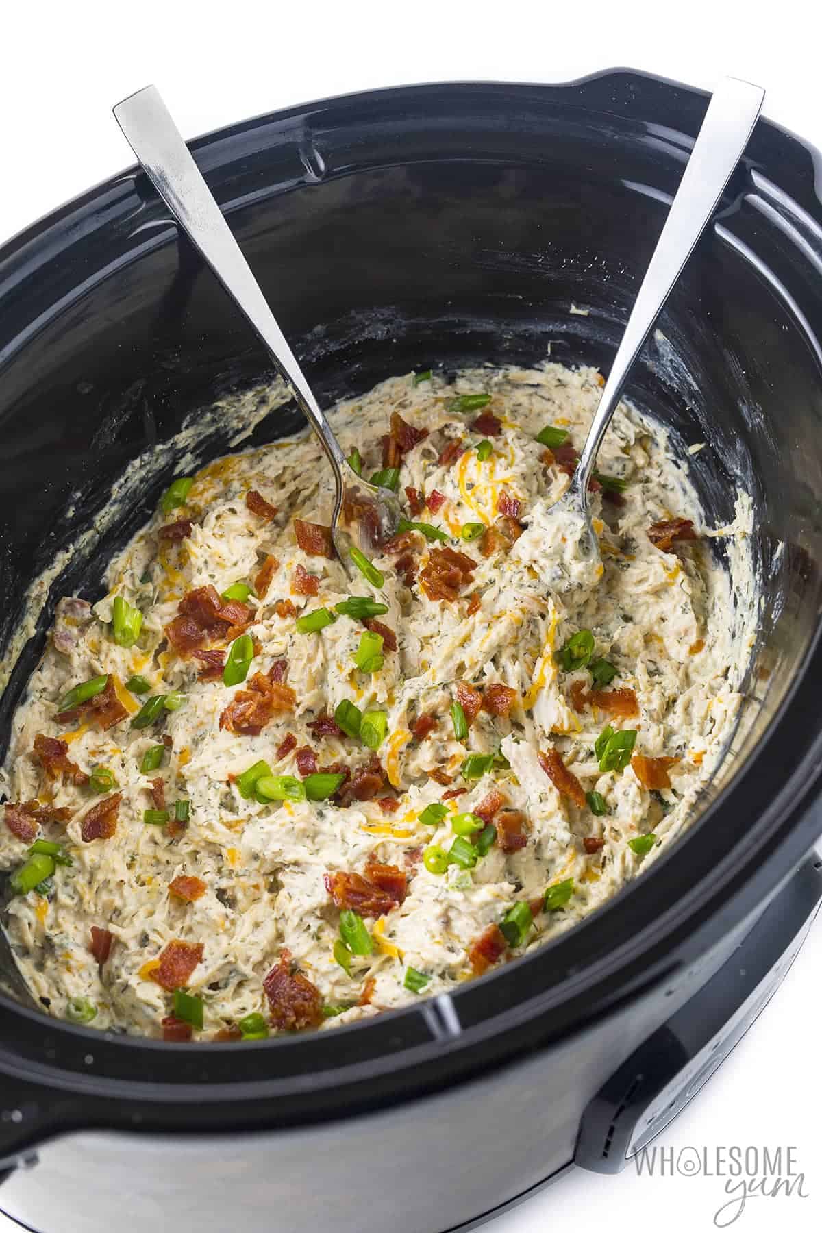 Easy slow cooker crack chicken recipe with forks.
