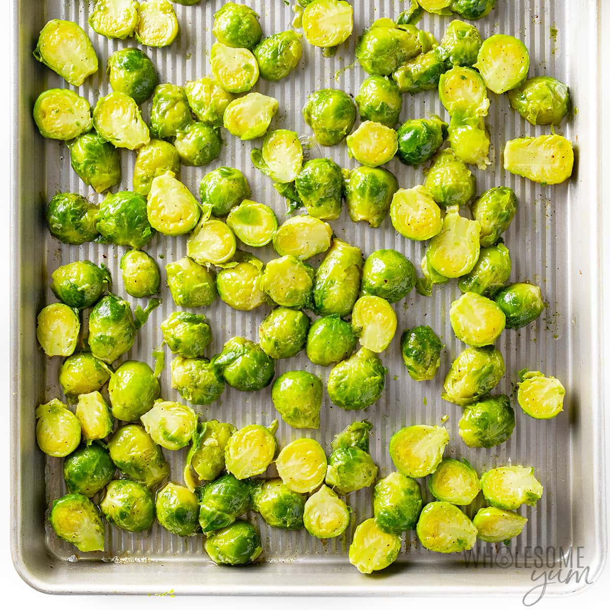 Brussels sprouts on a sheet pan, cut in half.