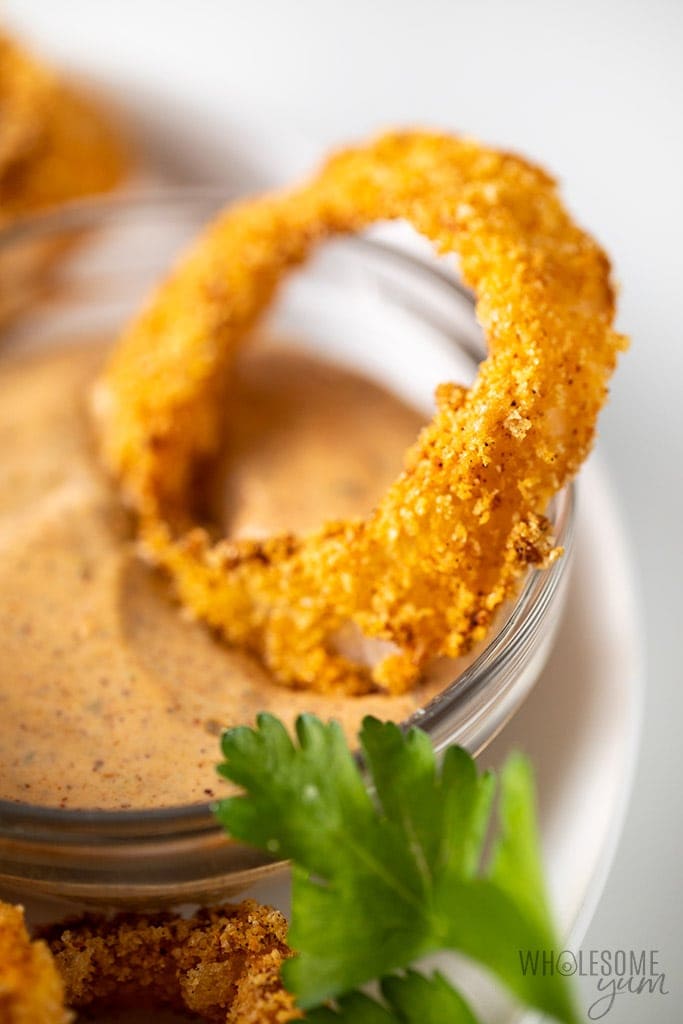 Air Fryer Keto Onion Rings Recipe - onion ring closeup with dipping sauce