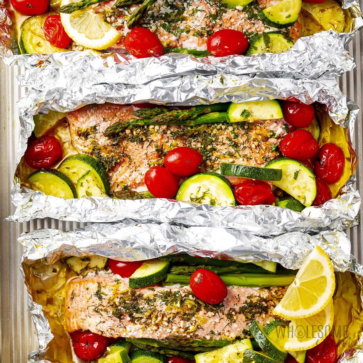 Salmon baked in foil on a baking sheet.