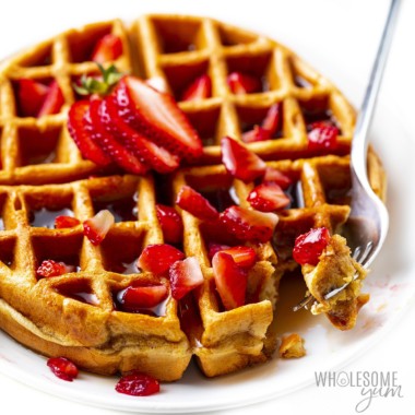 Protein waffles shown with strawberries and a fork.