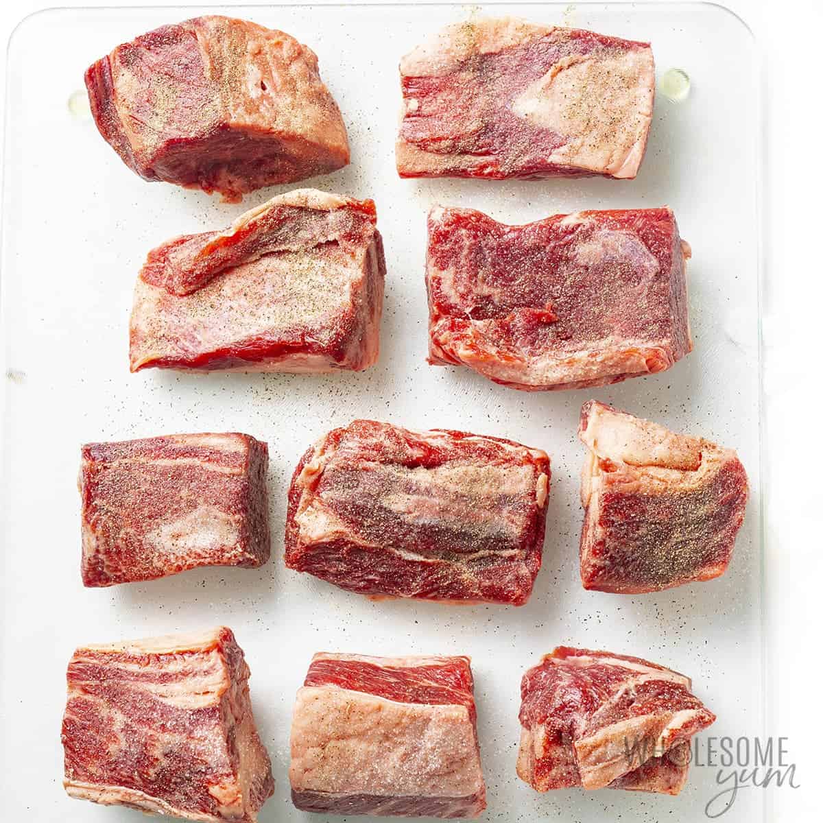 Boneless beef short ribs on a cutting board.