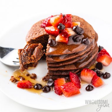 stack of chocolate protein pancakes with strawberries and chocolate chips