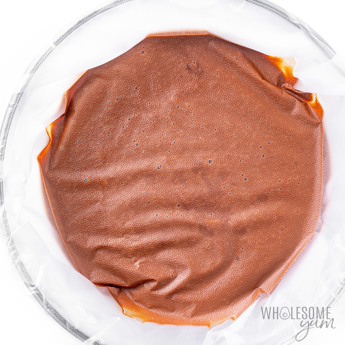 Sugar free chocolate pudding covered with plastic wrap.