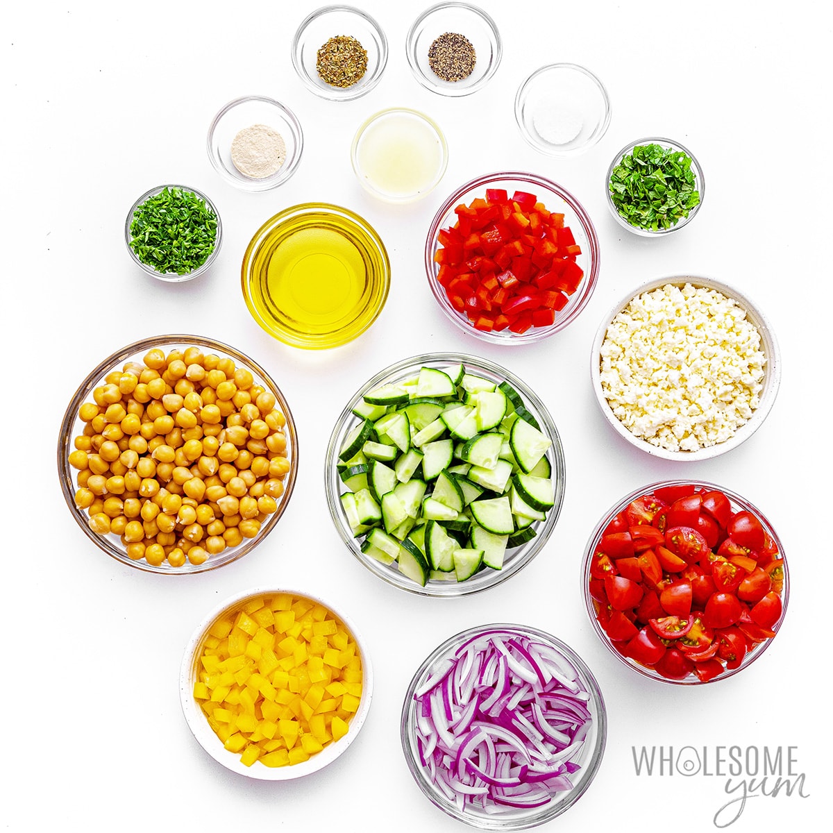 Mediterranean salad recipe ingredients measured out in bowls.