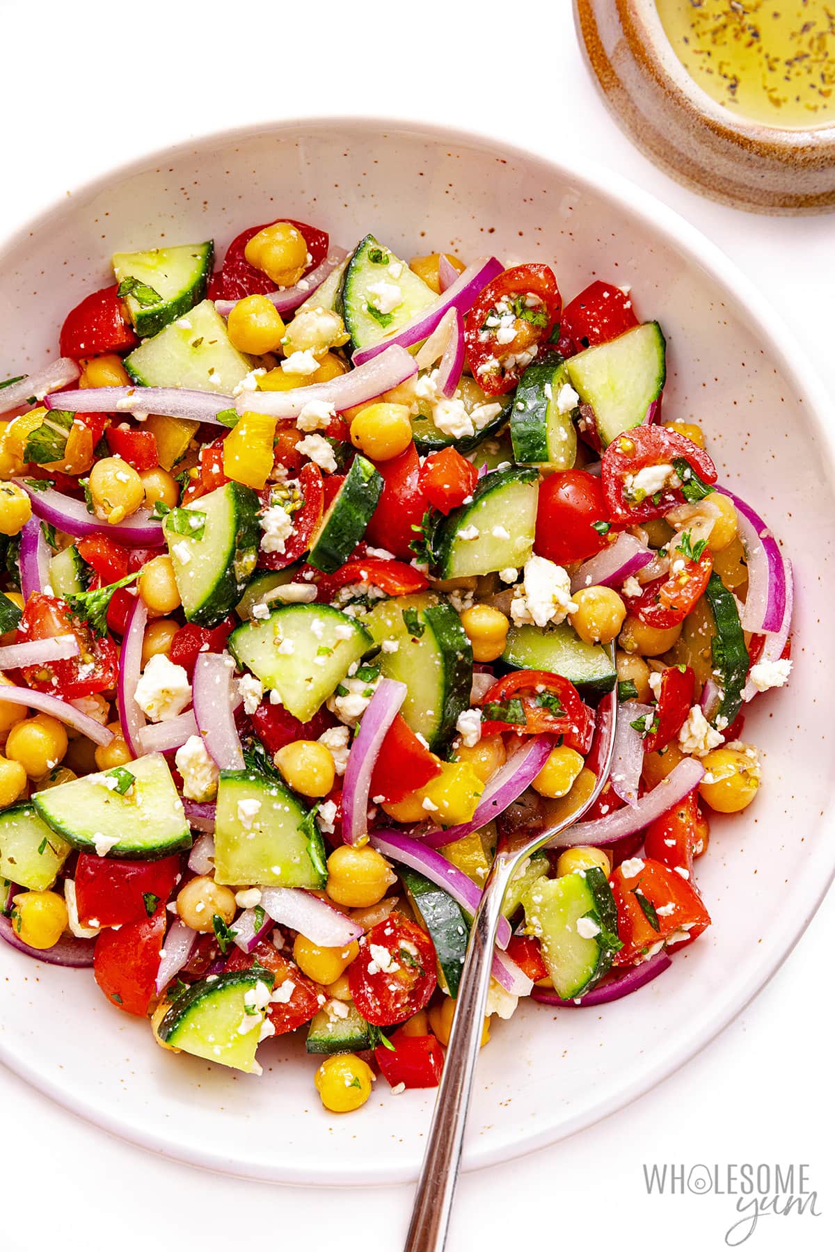 Mediterranean cucumber salad in a bowl with a fork.