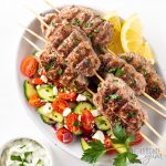 Lamb kofta kebabs on plate with Greek salad