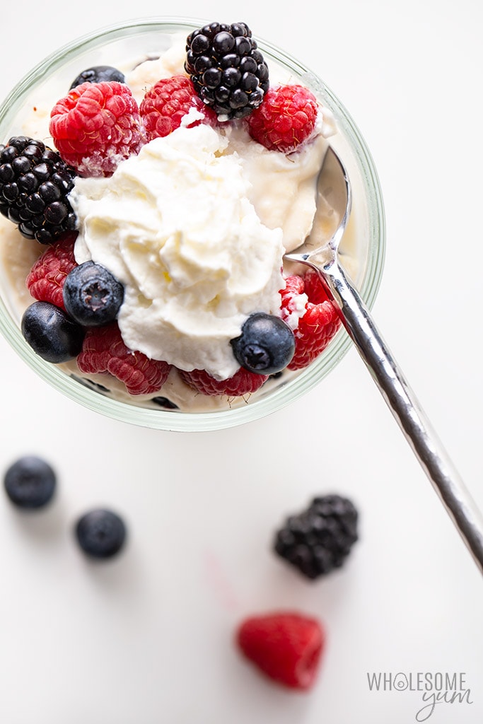 dish with low carb ricotta dessert and berries and whipped cream