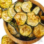 Baked zucchini chips recipe in a wooden bowl.