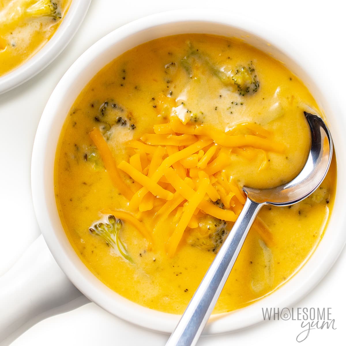 Easy broccoli cheese soup recipe with cheddar on top.