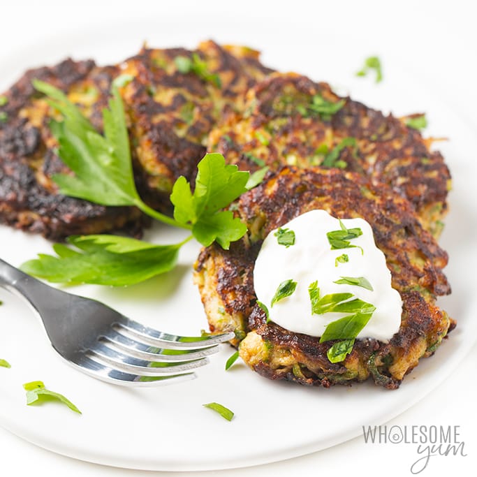 plateoflowcarbzucchinifritterswithsourcreamDetail:easy italian keto low carb zucchini fritters recipe