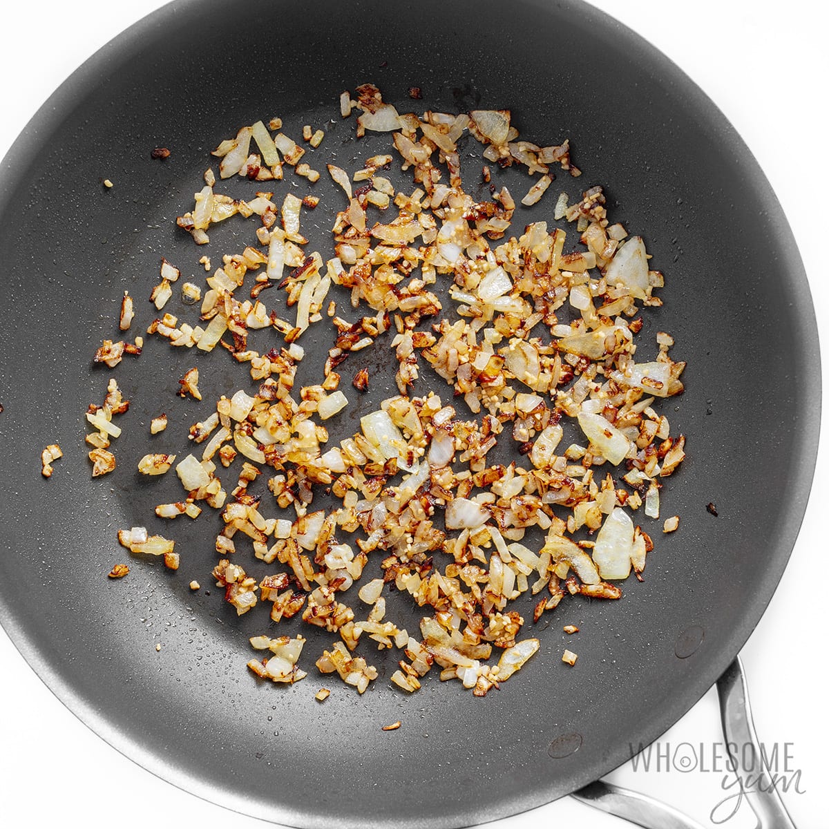 Sauteed onions in a skillet.