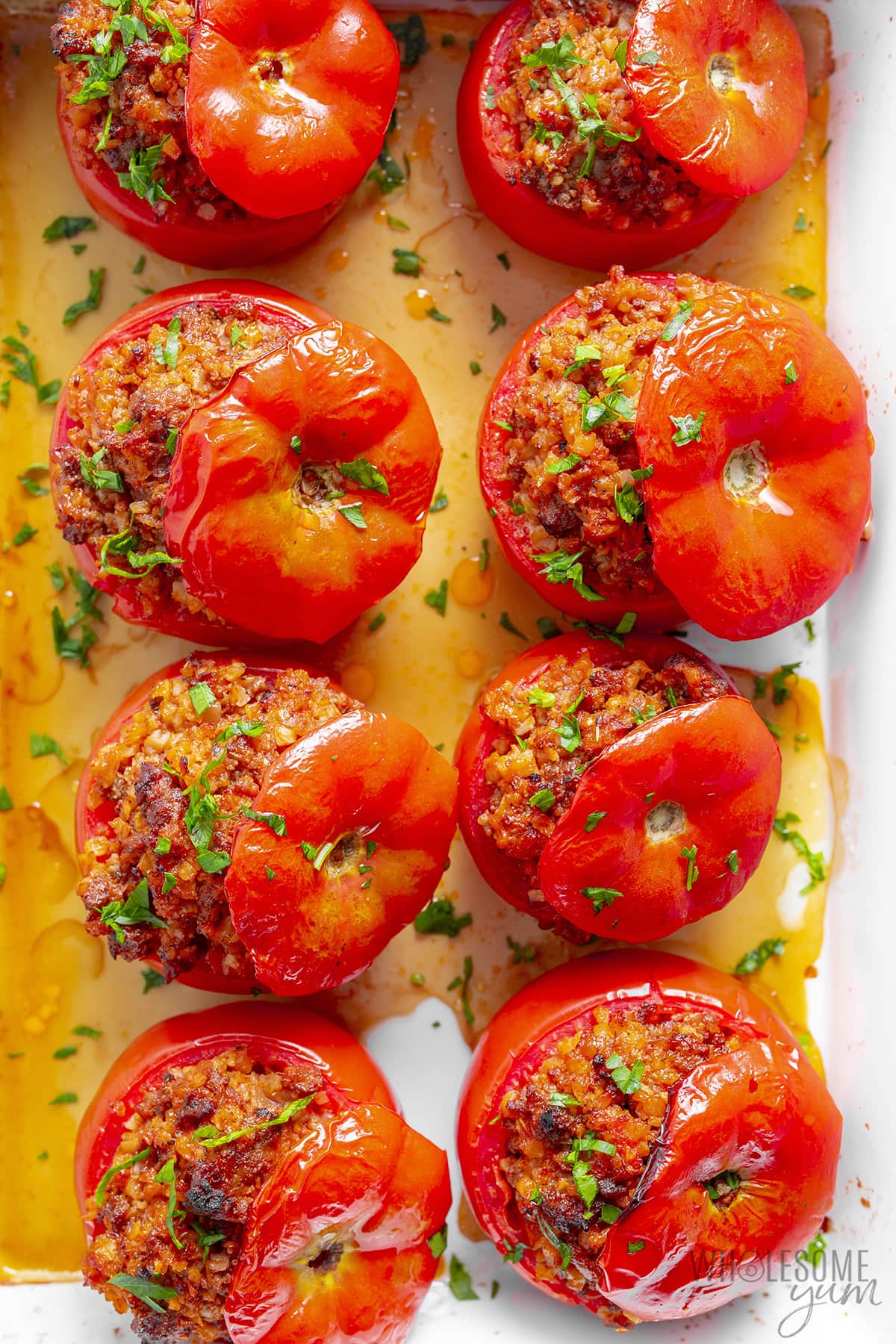 Baked stuffed tomatoes in a baking dish.