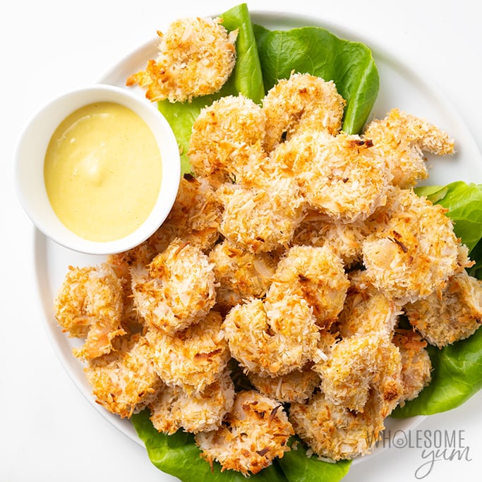 healthy coconut shrimp on a platter with dipping sauce