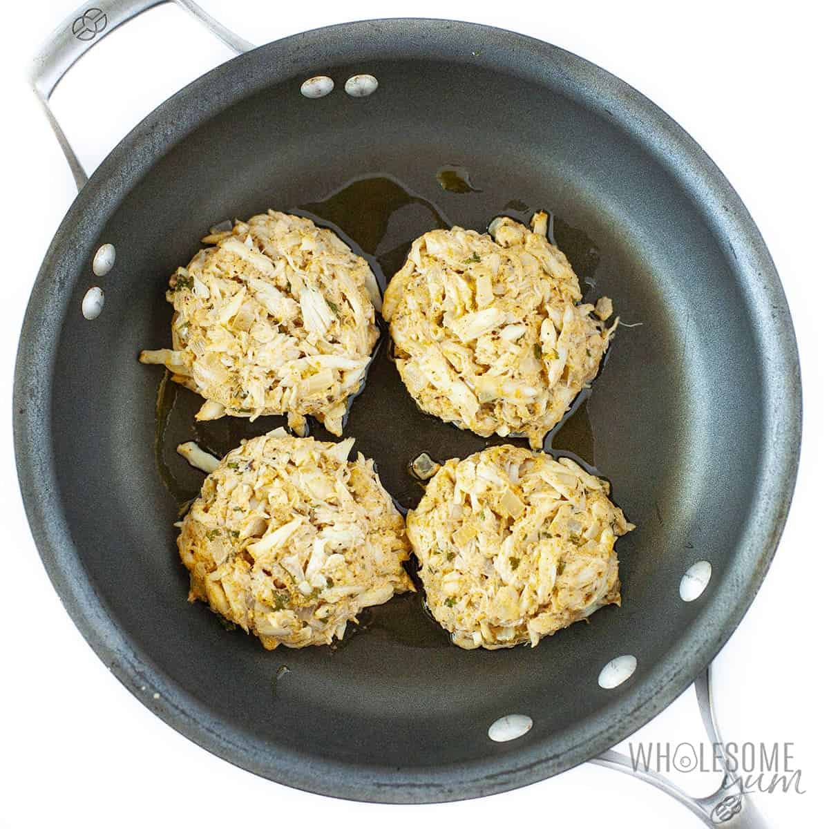 Keto crab cakes in a skillet.