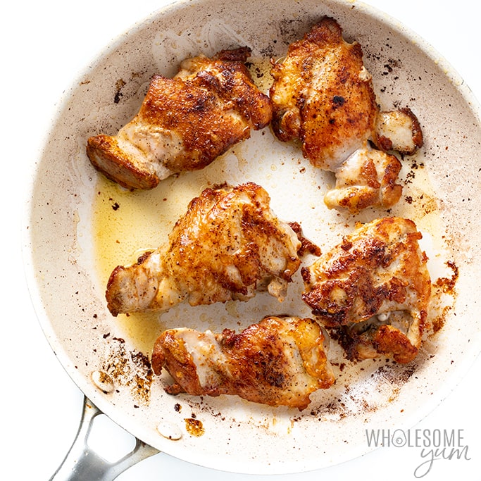 garlic chicken thighs searing in a pan