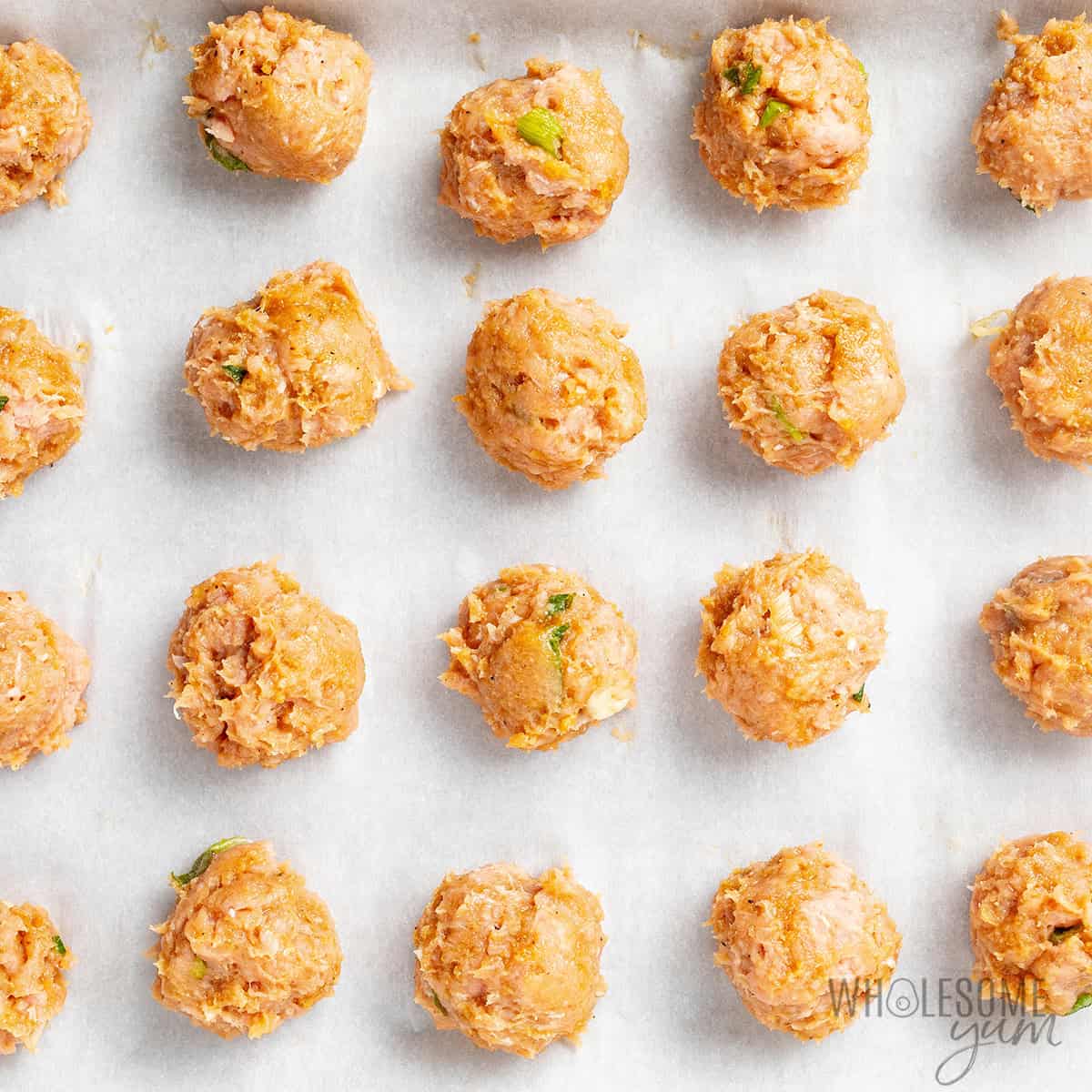 Meat mixture shaped into meatballs.