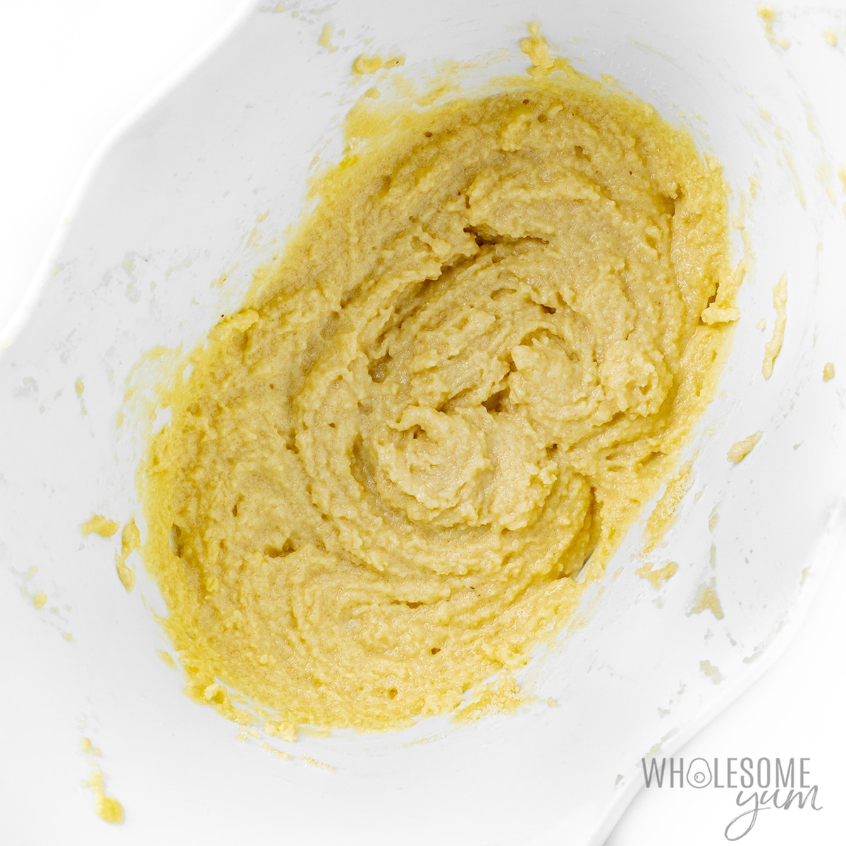 Fully combined almond flour cake batter in a mixing bowl.