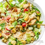 Chicken caesar salad on a plate.