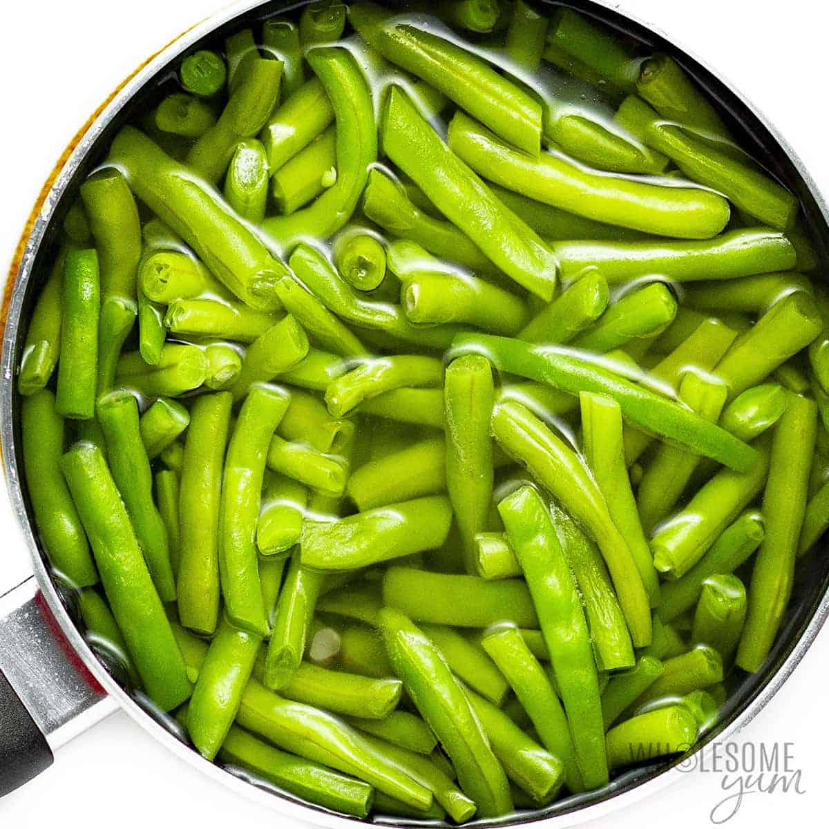 Green beans cooking in saucepan