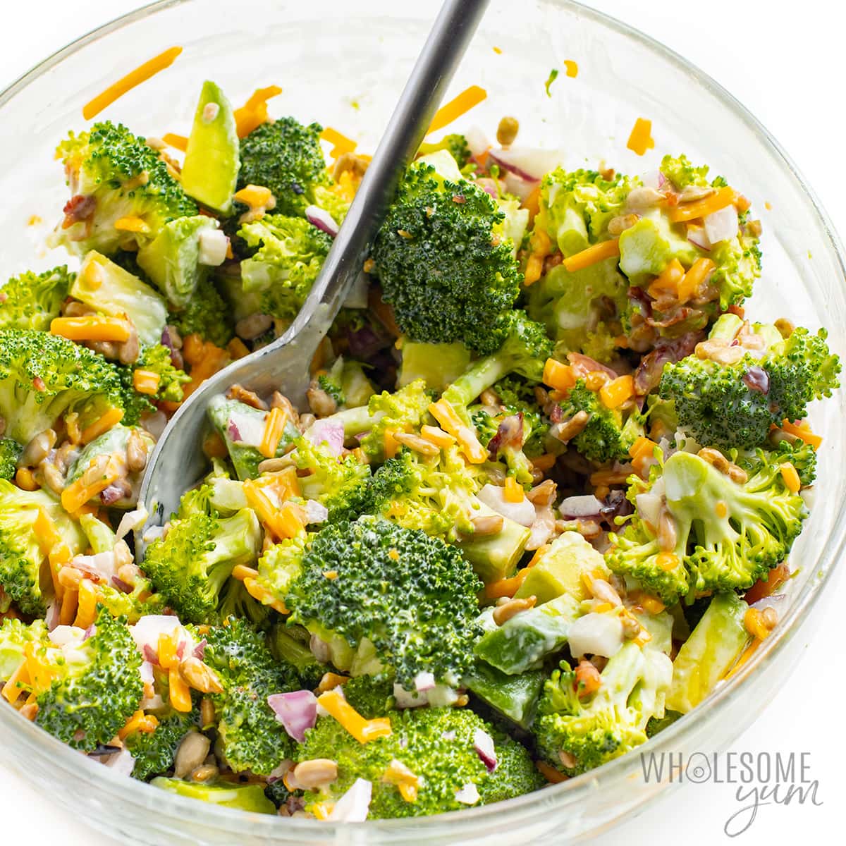 Low carb broccoli salad with bacon, dressing, and avocado mixed in.