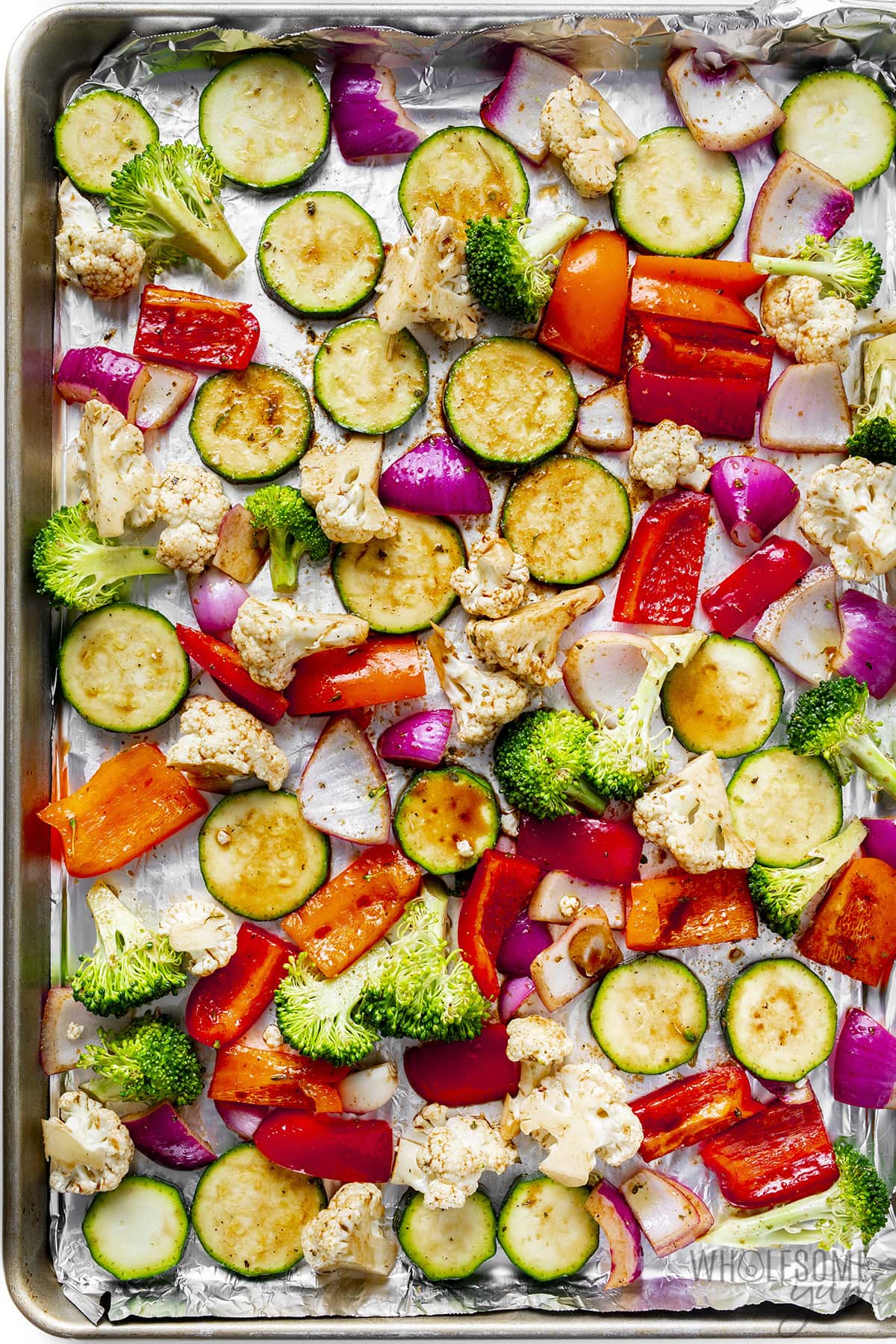 Seasoned veggies on a sheet pan.