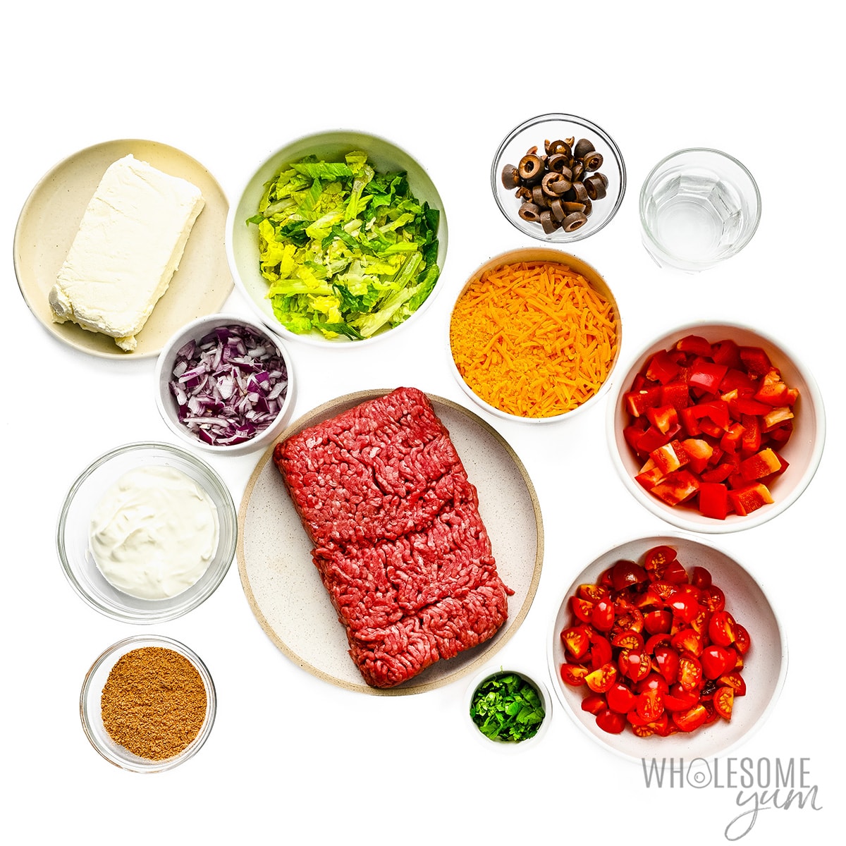 Taco dips ingredients into a bowl.