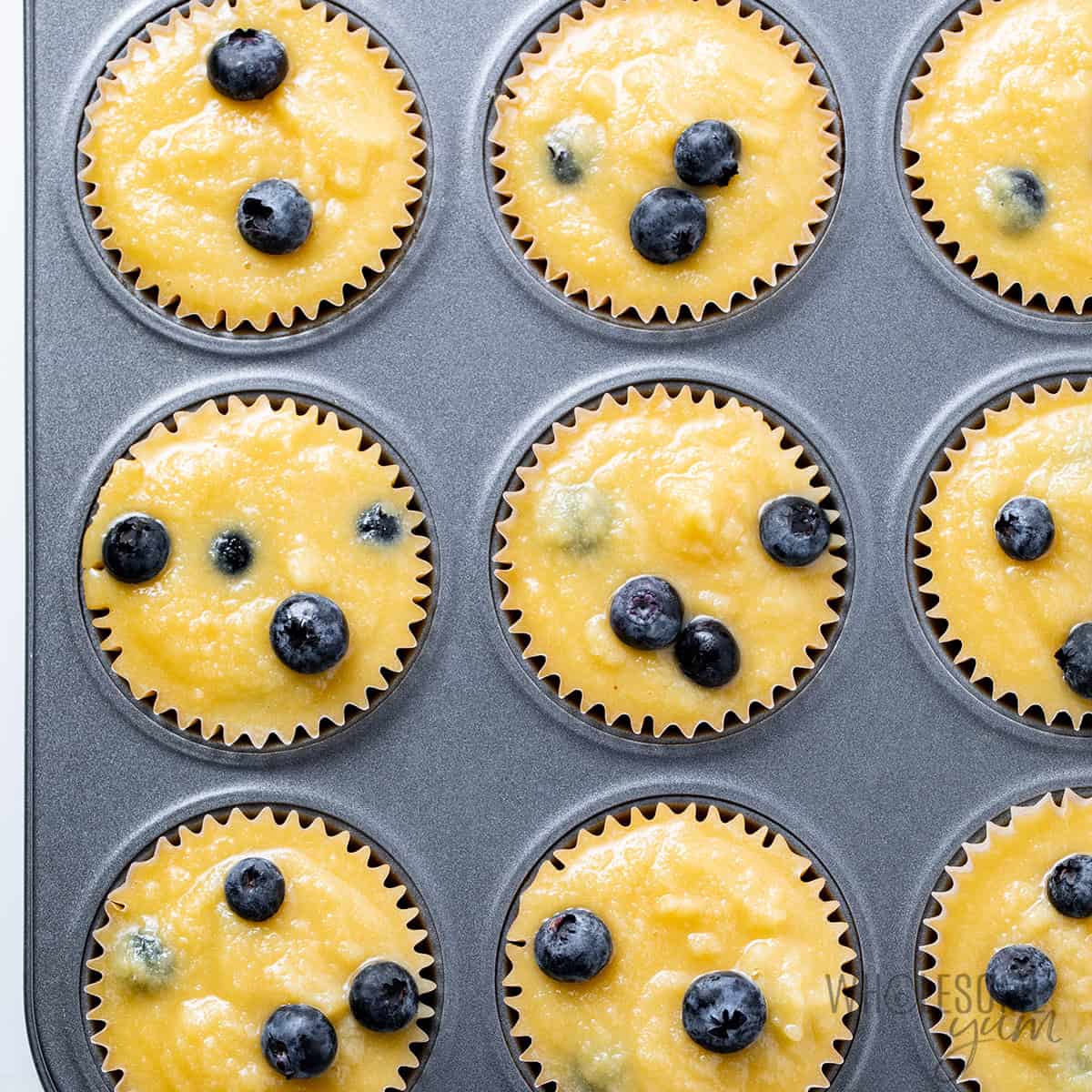 Muffin tin filled with batter.