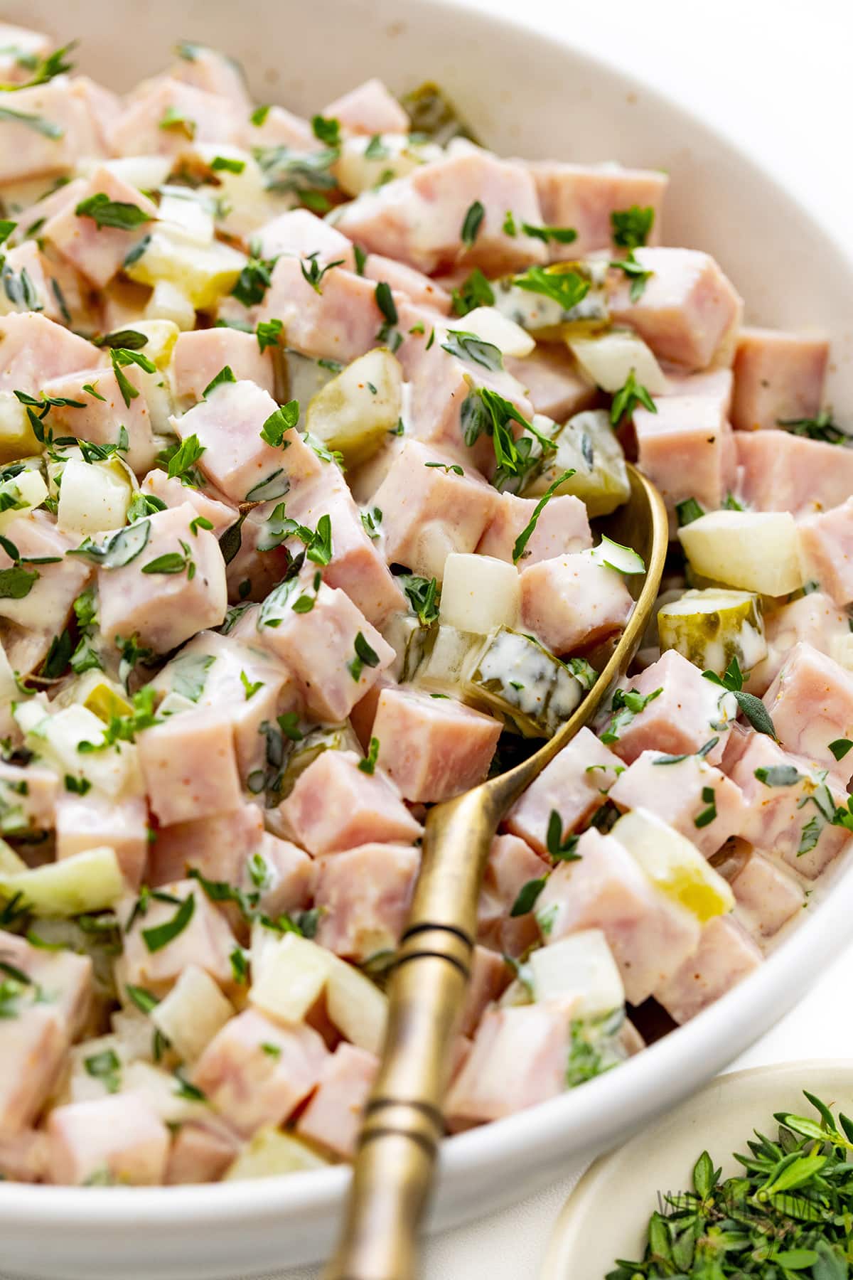 Ham salad in a bowl with a spoon.