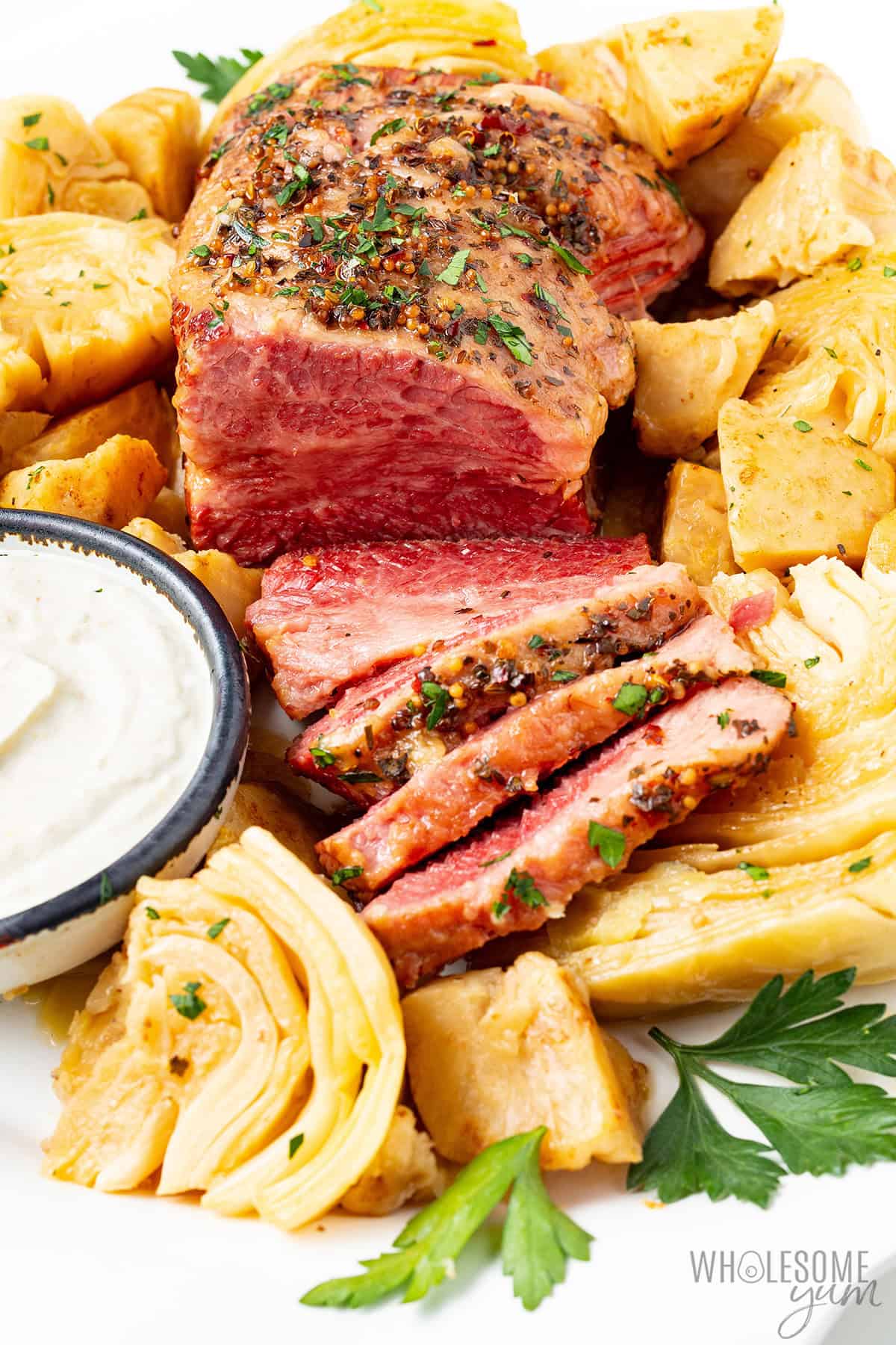 Juicy, tender corned beef and cabbage on a platter.