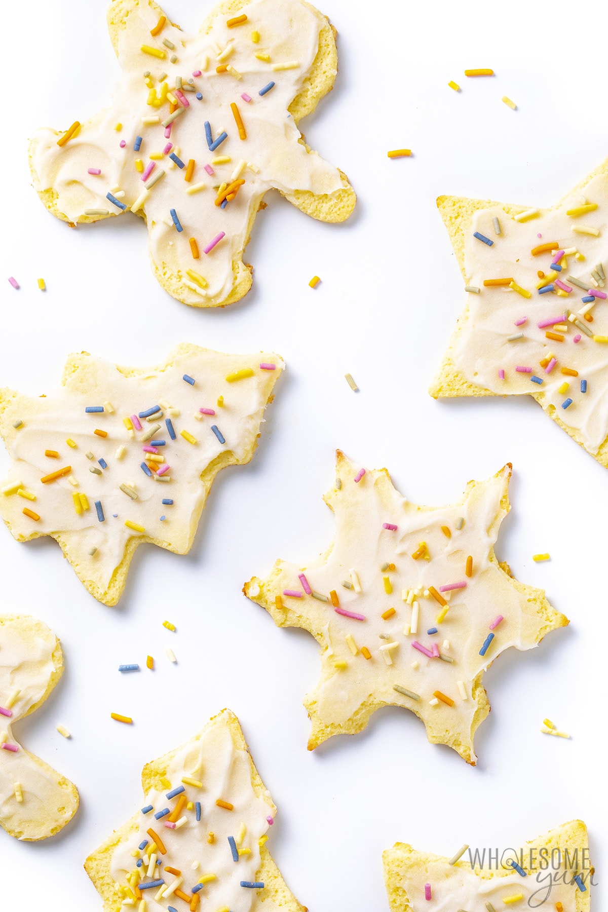 Christmas cutout coconut flour sugar cookies with frosting and sprinkles.