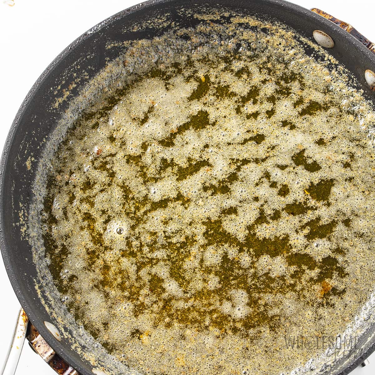 Melted browned butter in a pan.