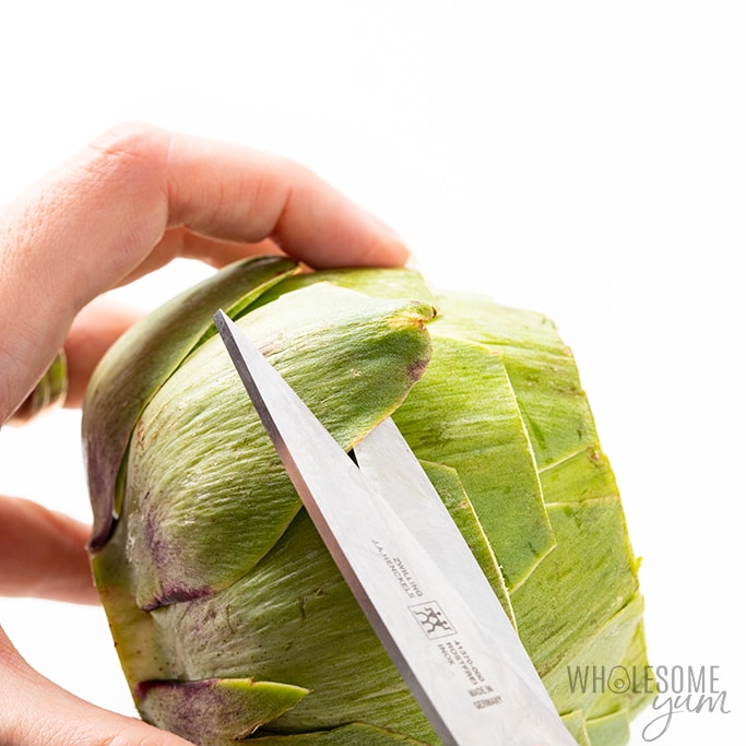 snipping off sharp leaves on artichoke